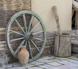 Old abandoned wheel against building