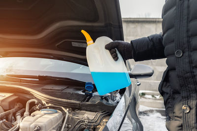 Cropped hand of man holding car