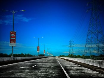 Road sign against blue sky