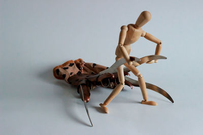 Close-up of figurine on table against white background