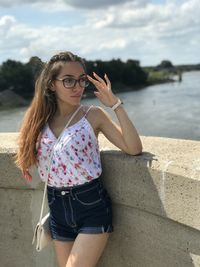 Young woman wearing sunglasses standing outdoors