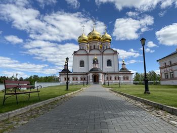 Church by building against sky