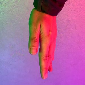 Low section of woman standing on pink flower