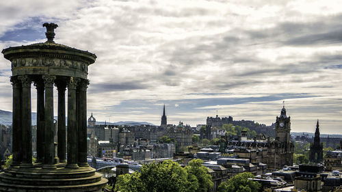 View of cityscape against cloudy sky