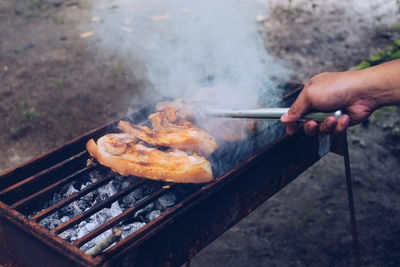 Man preparing food on barbecue grill