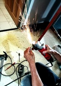 Low angle view of man working on metal