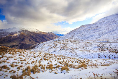 Snow mountain and crown range road between wanaka town - queenstown new zealand