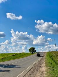 Road by land against sky