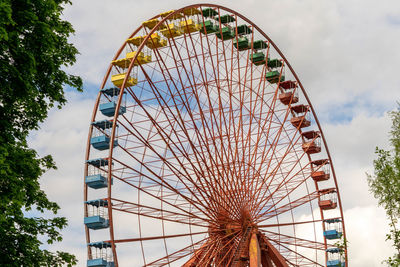 Low angle view of ferris wheel against sky