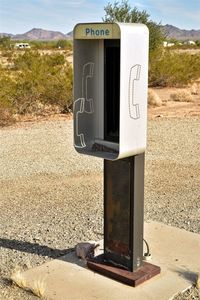 Close-up of telephone booth against sky