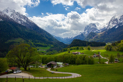 Scenic view of field and mountains against sky