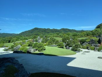 Scenic view of mountains against blue sky