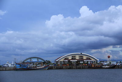 Bridge over river against buildings in city