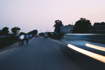 Blurred motion of car on road against clear sky