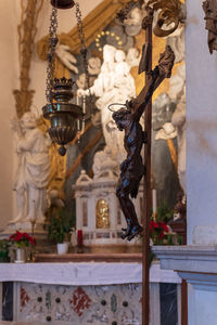 Close-up of statue hanging in temple outside building