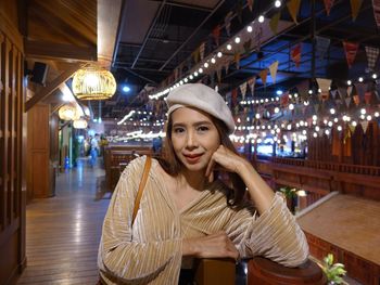 Portrait of smiling woman standing in restaurant