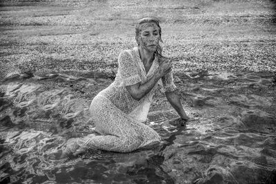Portrait of woman standing in water
