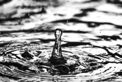 Close-up of drop splashing on water surface