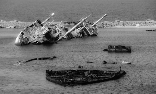 Abandoned boats in sea