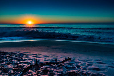 Scenic view of sea against clear sky during sunset