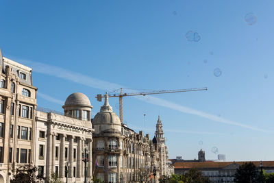 Low angle view of buildings against blue sky