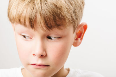 Close-up of boy against white background