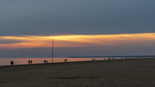 Scenic view of beach against sky during sunset