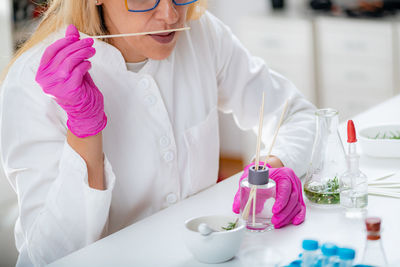 Perfumer holding a stick with aromatic oil.