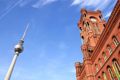 Low angle view of rotes rathaus and fernsehturm against sky