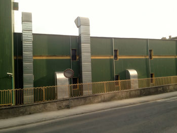 Street lights on road against buildings in city