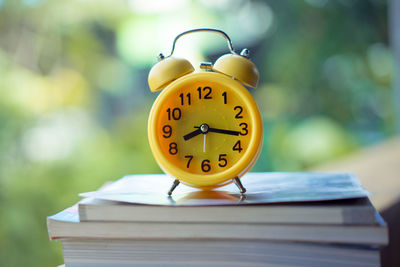 Close-up of clock on open book