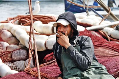 Portrait of man relaxing on rope