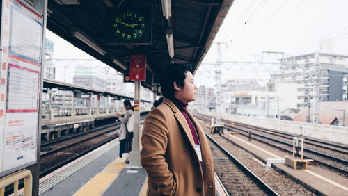 Full length of man standing at railroad station