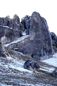 Rock formation against sky during winter