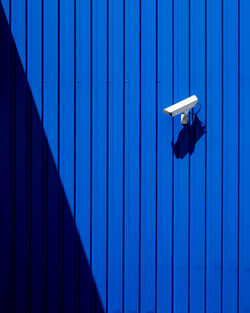 Full frame shot of observationcamera against blue wall