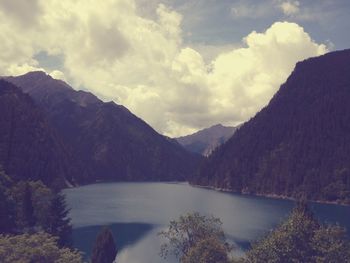 Scenic view of lake and mountains against sky