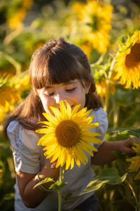 Rear view of girl with sunflower