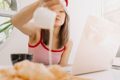 Midsection of woman using laptop