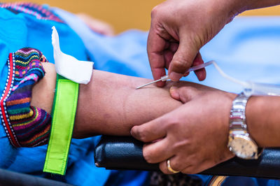 Close-up of doctor injecting syringe to patient
