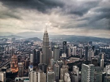 Cityscape against cloudy sky