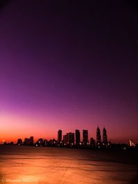 Silhouette buildings against sky during sunset