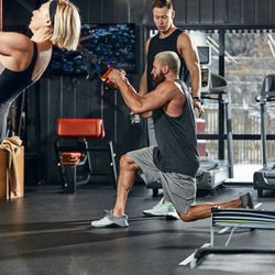 Side view of woman exercising in gym