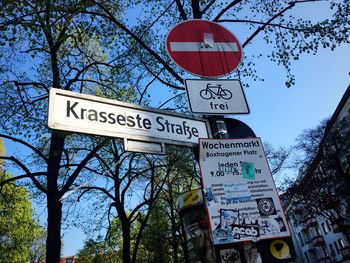 Low angle view of road sign against sky