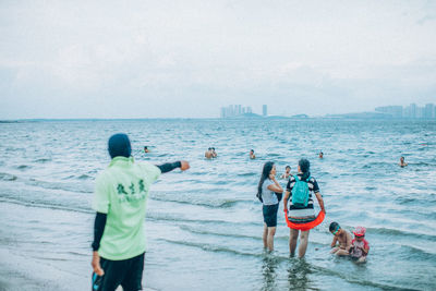 Rear view of people on beach