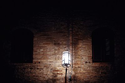 Street light on wall of old building