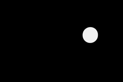 Low angle view of moon against clear sky at night