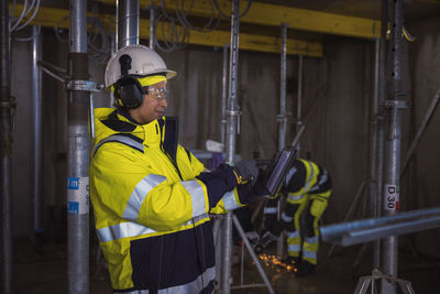 Engineer at building site using digital tablet