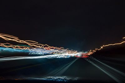 Light trails against sky at night