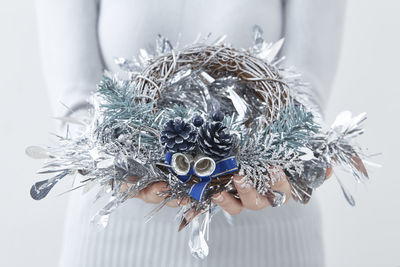 Close-up of woman holding christmas decoration