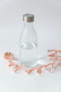 Close-up of wine glass on table against white background